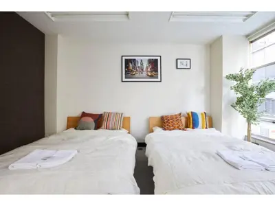 two beds in a room with white sheets at Tora Hotel Taito - Vacation STAY 53048v in Tokyo
