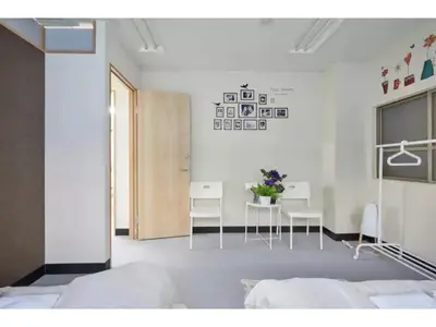 a bedroom with a bed and a table and chairs at Tora Hotel Taito - Vacation STAY 53053v in Tokyo