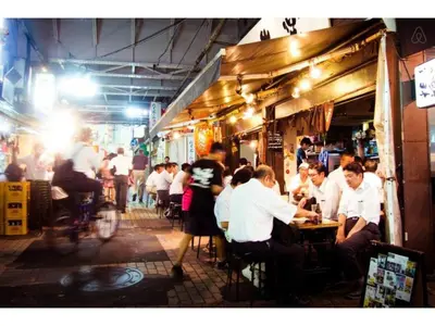 a group of people sitting at tables in a restaurant at Tora Hotel Taito - Vacation STAY 53053v in Tokyo