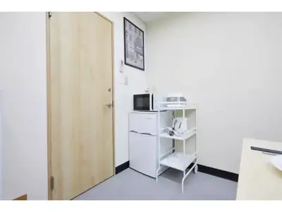 a small room with a door and a microwave at Tora Hotel Taito - Vacation STAY 53053v in Tokyo