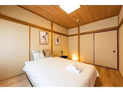 a bedroom with a large white bed with a ceiling at Tora Hotel Taito - Vacation STAY 53094v in Tokyo
