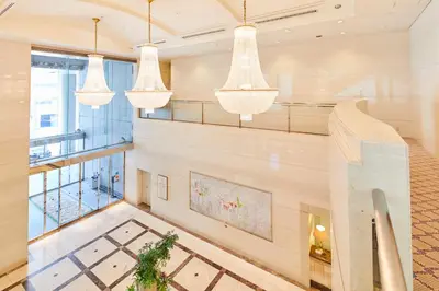 a lobby with chandeliers in a building at Hotel Le Port Kojimachi in Tokyo