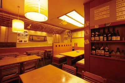 a restaurant with tables and chairs and bottles of wine at Hotel Le Port Kojimachi in Tokyo