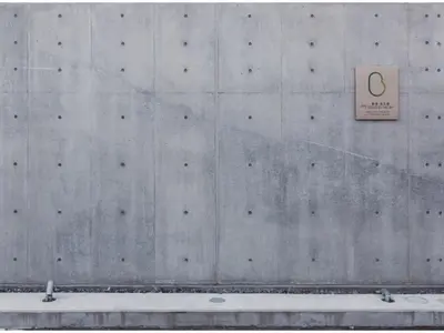 a concrete wall with a sign on it at bmj Shinjuku Okubo - Vacation STAY 46884v in Tokyo