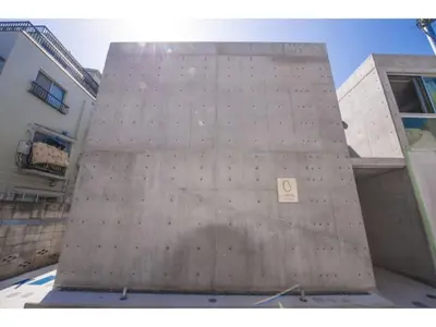 a tall concrete building with a sign on it at bmj Shinjuku Okubo - Vacation STAY 46885v in Tokyo