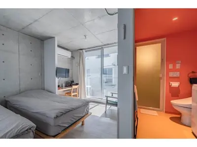 a small bedroom with a bed and a bathroom at bmj Shinjuku Okubo - Vacation STAY 46885v in Tokyo