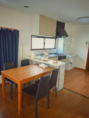 a kitchen with a wooden dining table and chairs at Uhome Ueno Hotel in Tokyo