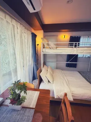 a bedroom with a bunk bed and a table at Uhome Ueno Hotel in Tokyo