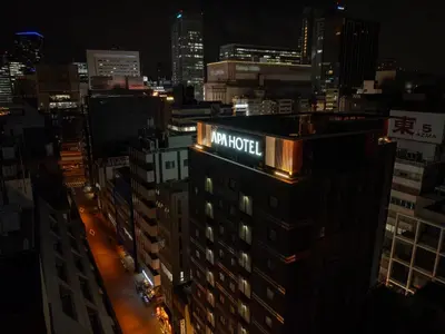 a sign on the top of a building at night at APA Hotel Akihabara Ekihigashi in Tokyo