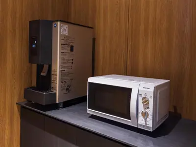 a microwave and a coffeemaker sitting on a counter at APA Hotel Akihabara Ekihigashi in Tokyo