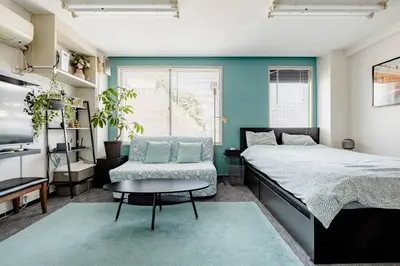 a bedroom with a bed and a chair and a table at \u3055\u304f\u3089\u30a4\u30f3\u99c5\u524d\u7652\u3084\u3057\u7a7a\u9593 in Tokyo