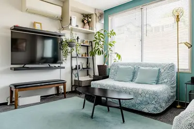a living room with a couch and a tv at \u3055\u304f\u3089\u30a4\u30f3\u99c5\u524d\u7652\u3084\u3057\u7a7a\u9593 in Tokyo