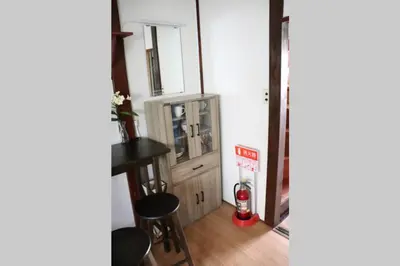 a room with a television and a table and stool at \u30ea\u30c6\u30c3\u30af\u30b9\u6d66\u5b89 in Tokyo