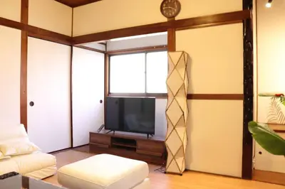 a living room with a couch and a tv at \u30ea\u30c6\u30c3\u30af\u30b9\u6d66\u5b89 in Tokyo