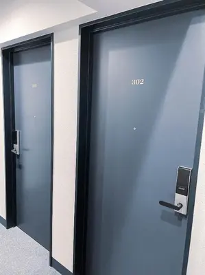 a row of elevators in an office building at Hotel Plaisir Akihabara in Tokyo