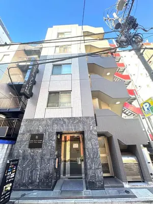 a building with a sign on the side of it at Hotel Plaisir Akihabara in Tokyo