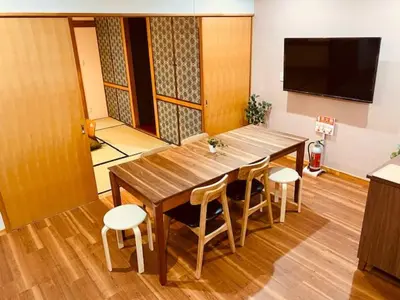 a large wooden table and chairs in a room at Ostay Numabukuro Hotel Apartment in Tokyo
