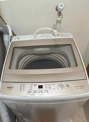 a washing machine in a bathroom with its door open at Ostay Numabukuro Hotel Apartment in Tokyo