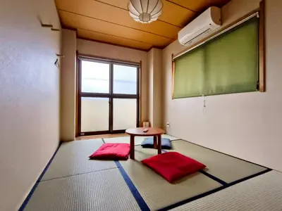 a classroom with a chalkboard and a table and a window at Ostay Numabukuro Hotel Apartment in Tokyo