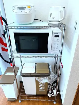 a shelf with a microwave and other appliances on it at SKYE HOME MINPAKU - Vacation STAY 11856 in Tokyo