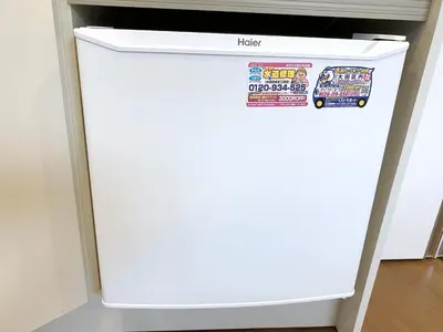 a white refrigerator in a kitchen with stickers on it at SKYE HOME MINPAKU - Vacation STAY 11856 in Tokyo