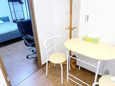 a room with a table and a bed and a mirror at SKYE HOME MINPAKU - Vacation STAY 11856 in Tokyo