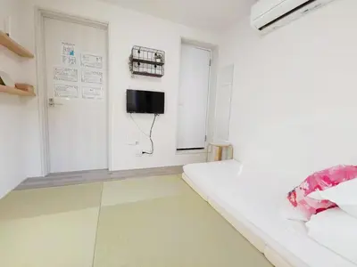 a room with a bed and a television on a wall at YUYU-Wa-3 --Self Check-in -- Room Number & Password is in the following email in Tokyo