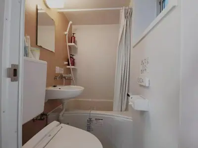 a small bathroom with a toilet and a sink at YUYU-Wa-3 --Self Check-in -- Room Number & Password is in the following email in Tokyo