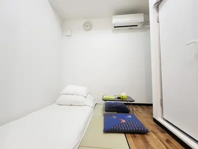 a small room with a bed and a table at KYU KYU HOTEL in Tokyo