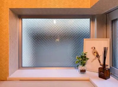 a window with a bird sitting on a window sill at japan house nishishinjuku in Tokyo