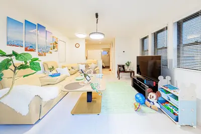a living room with a couch and a tv at CuteFamilyHouse! 6minShinjuku 6minSta FreeParking Cozy,Bright KidsFree Under6yrs in Tokyo