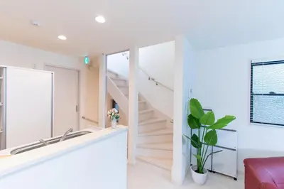 a staircase in a white room with a mirror at CuteFamilyHouse! 6minShinjuku 6minSta FreeParking Cozy,Bright KidsFree Under6yrs in Tokyo