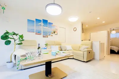 a living room with a couch and a table at CuteFamilyHouse! 6minShinjuku 6minSta FreeParking Cozy,Bright KidsFree Under6yrs in Tokyo