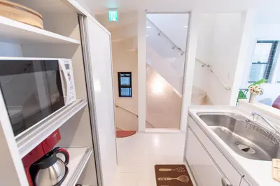 a small kitchen with a sink and a refrigerator at CuteFamilyHouse! 6minShinjuku 6minSta FreeParking Cozy,Bright KidsFree Under6yrs in Tokyo