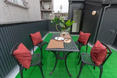 a table and chairs on a balcony with green grass at CuteFamilyHouse! 6minShinjuku 6minSta FreeParking Cozy,Bright KidsFree Under6yrs in Tokyo