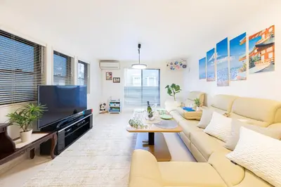 a living room with a couch and a tv at CuteFamilyHouse! 6minShinjuku 6minSta FreeParking Cozy,Bright KidsFree Under6yrs in Tokyo