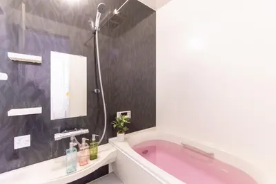 a bathroom with a pink tub and a mirror at CuteFamilyHouse! 6minShinjuku 6minSta FreeParking Cozy,Bright KidsFree Under6yrs in Tokyo