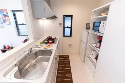 a kitchen with a sink and a refrigerator at CuteFamilyHouse! 6minShinjuku 6minSta FreeParking Cozy,Bright KidsFree Under6yrs in Tokyo