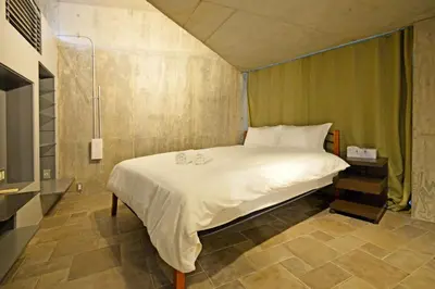a bedroom with a bed with two candles on it at MONO - Vacation STAY 54271v in Tokyo