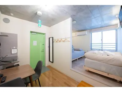 a bedroom with a bed and a desk and a table at bmj Hyakunincho - Vacation STAY 68273v in Tokyo