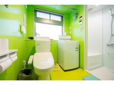 a green bathroom with a toilet and a shower at bmj Hyakunincho - Vacation STAY 68273v in Tokyo