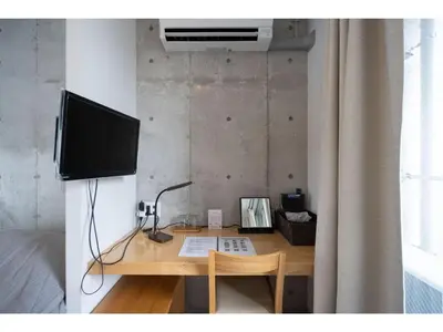 a desk with a television and a computer on it at bmj Shinjuku Okubo - Vacation STAY 68282v in Tokyo