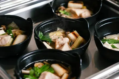 a group of four bowls of food on a stove at Keisei Richmond Hotel Tokyo Oshiage in Tokyo