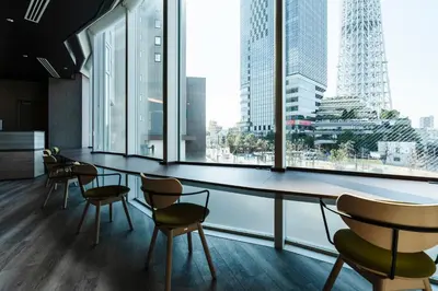 a room with chairs and windows with a view of a city at Keisei Richmond Hotel Tokyo Oshiage in Tokyo