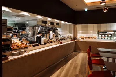 a kitchen with a chef preparing food in a restaurant at Keisei Richmond Hotel Tokyo Oshiage in Tokyo