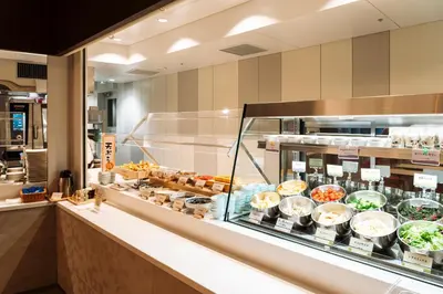 a display case in a restaurant with many different foods at Keisei Richmond Hotel Tokyo Oshiage in Tokyo