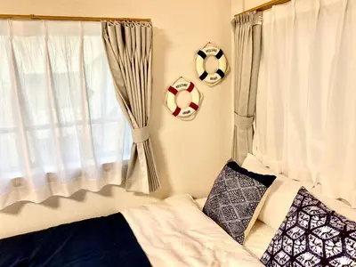 a bedroom with a bed and two soccer balls on the wall at \u30ef\u30f3\u30cf\u30a6\u30b9\u65b0\u5c0f\u5ca9 in Tokyo