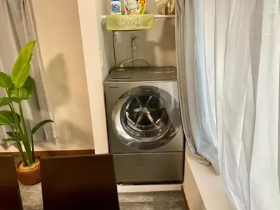 a washing machine in a corner of a room at \u30ef\u30f3\u30cf\u30a6\u30b9\u65b0\u5c0f\u5ca9 in Tokyo