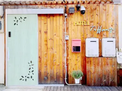 a wooden wall with a door and aperature at Hotel Tiffany in Tokyo