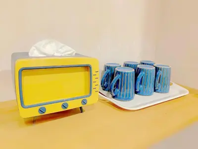 a yellow and blue toaster and blue cups on a table at Hotel Tiffany in Tokyo